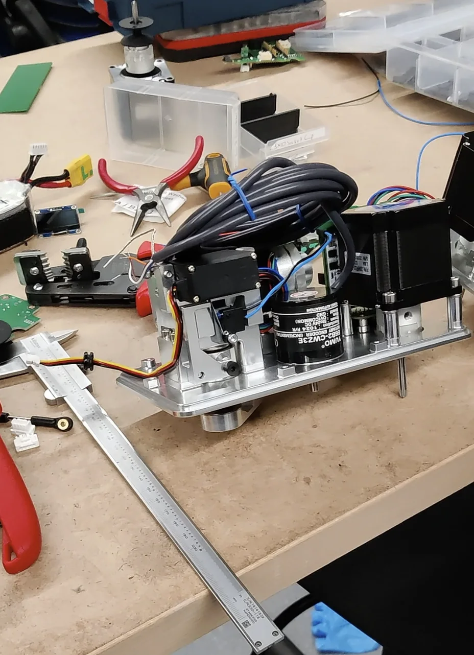 Automated spooling machine prototype with motors and wiring on a workbench