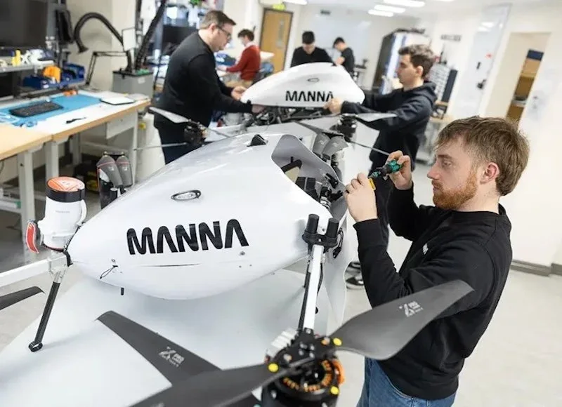 People assembling Manna delivery drones in a workshop